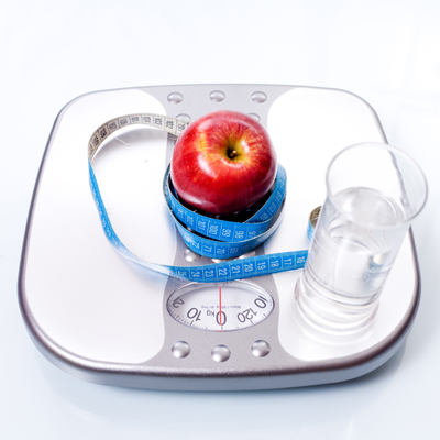Weight scale, apple and glass of water